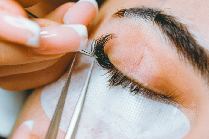 A close up of a person cutting a persons eye Organic Beauty Salon
